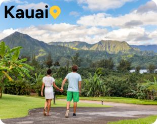 Couple walking with Mountains in the background on Kauai Hawaii